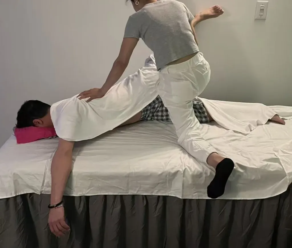 Therapist applying back pressure during an assisted stretch